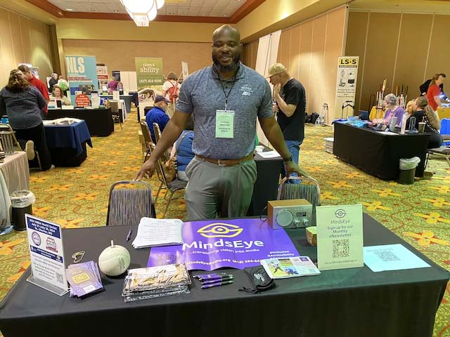 Jason Frazier with MindsEye Exhibit Table