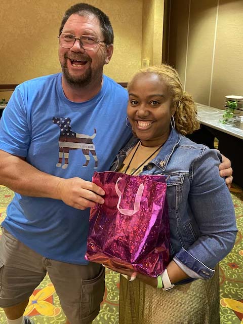 Raffle winner, Darlisa, holding a Scentsy surprise gift bag.
